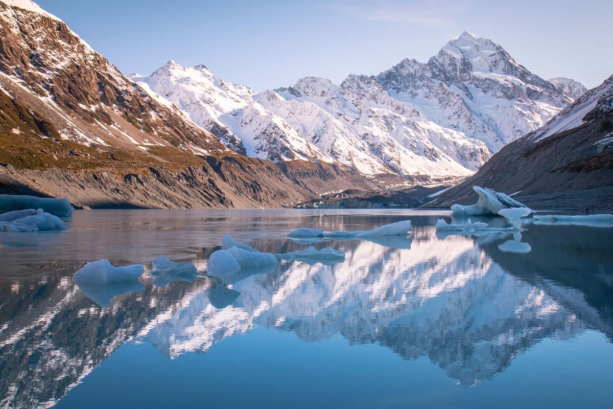 White RV driving through the impressive landscapes of New Zealand's South Island