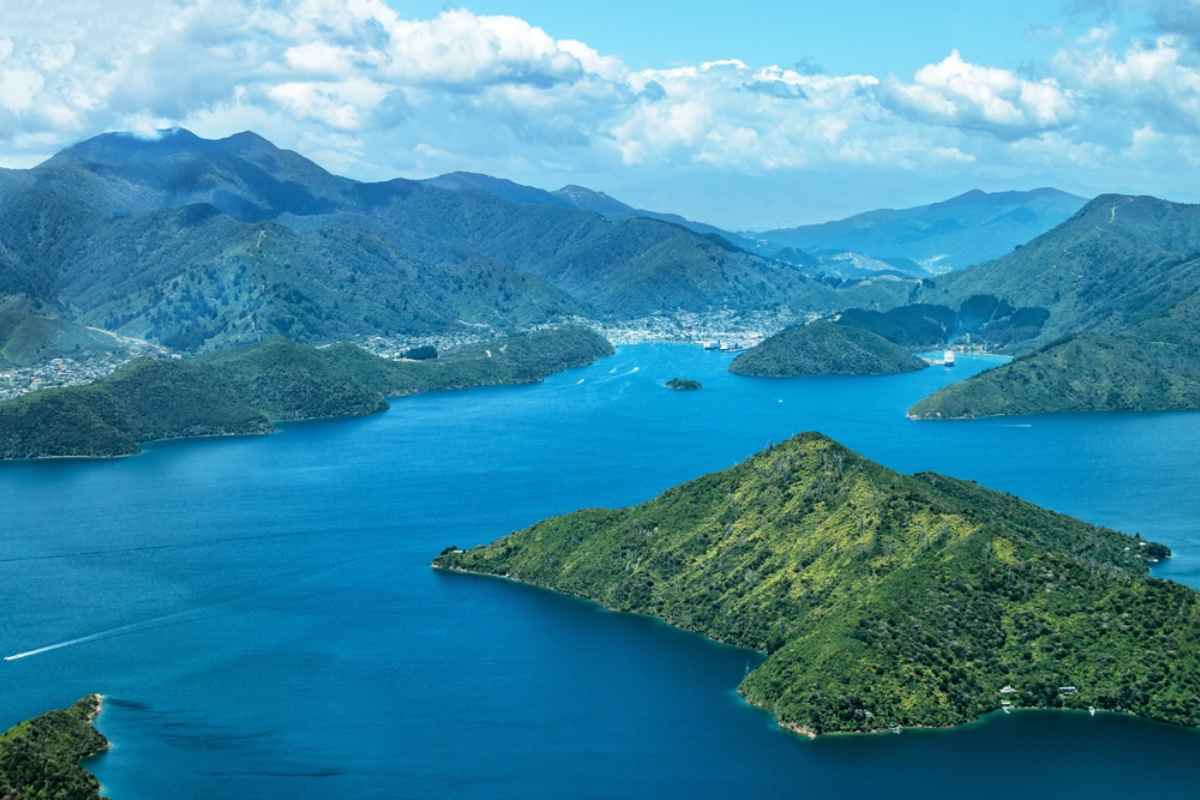 Drone view of several mountain ranges and islands on a sunny day