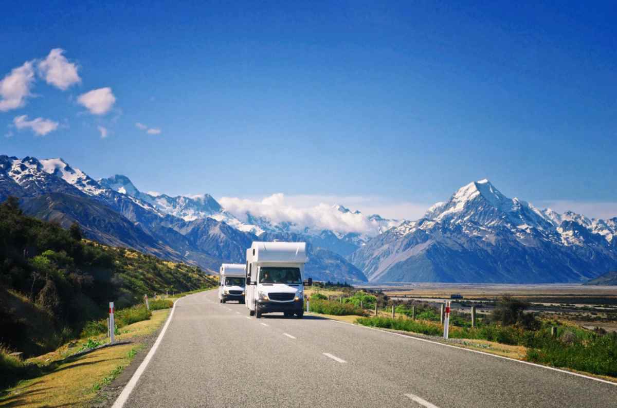 Motorhomes on the road with impressive views of a mountain rage in the background